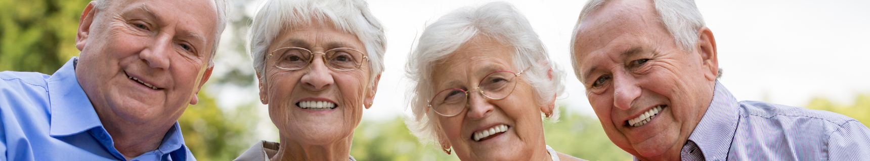 two elderly couples smiling