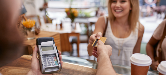 woman using credit card at coffee shop