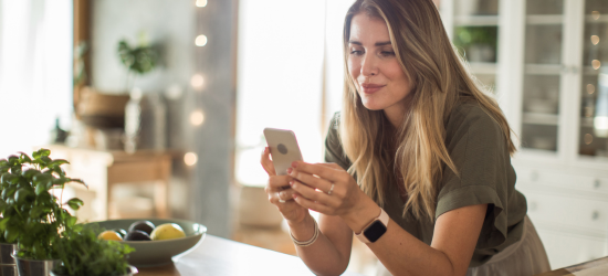 woman using cellphone to order checks