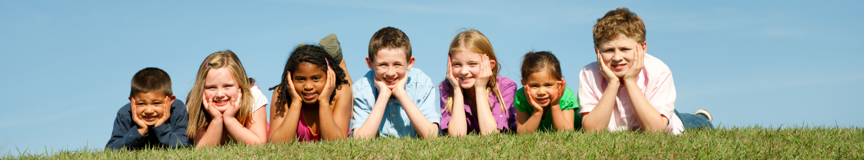 kids laying on grass