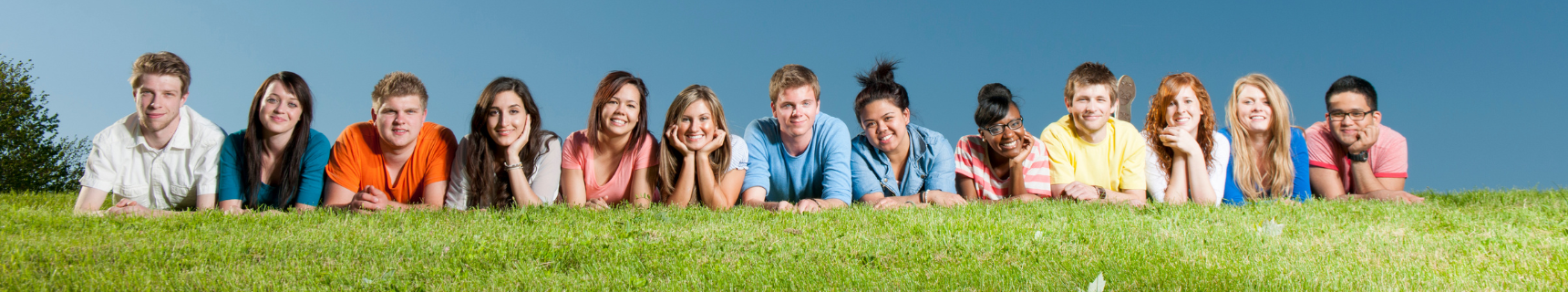 teens laying on grass