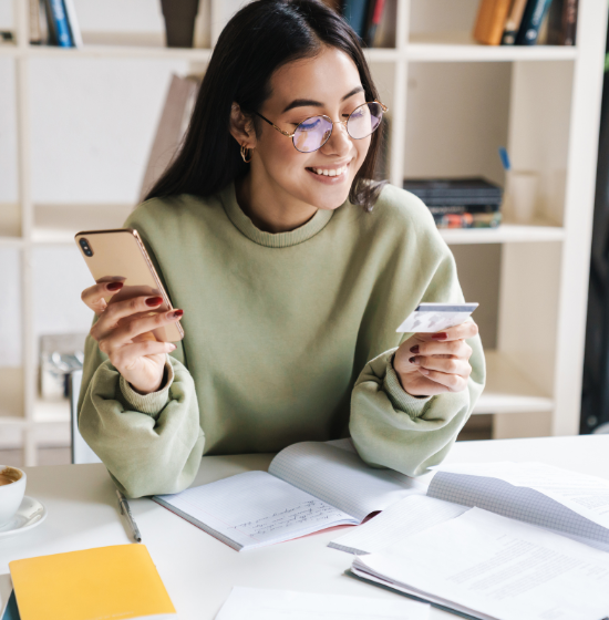 woman using credit card with phone