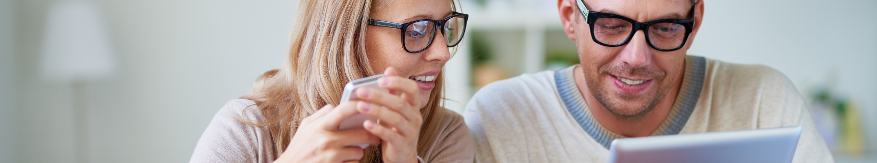 couple in glasses looking at computer