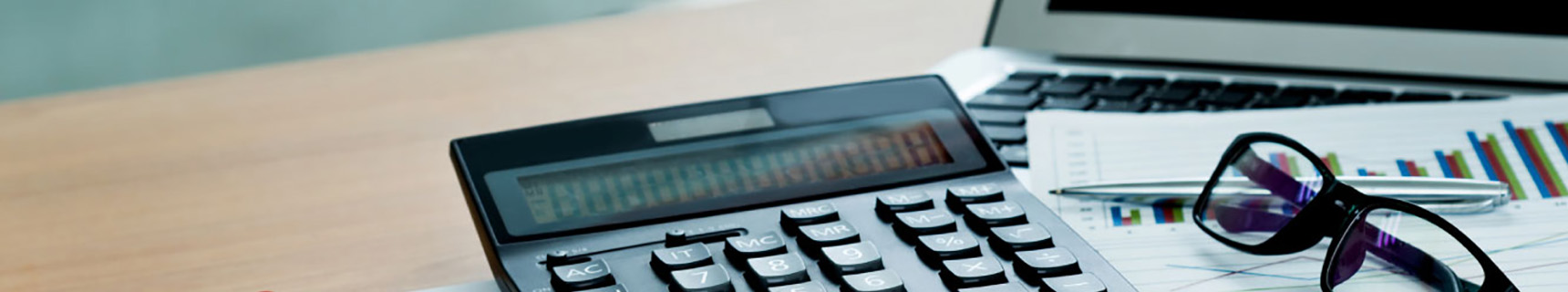 calculator next to a computer